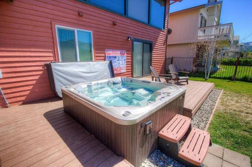 a hot tub on a deck next to a house at Epiphany home in South Lake Tahoe