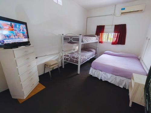 a small bedroom with a bunk bed and a tv at Dptos Reynoso in Villa Mercedes