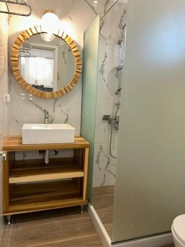 a bathroom with a sink and a mirror at Poseidon Garden View Apartment in Perivólion