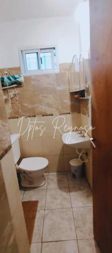 a bathroom with a toilet and a sink at Dptos Reynoso in Villa Mercedes