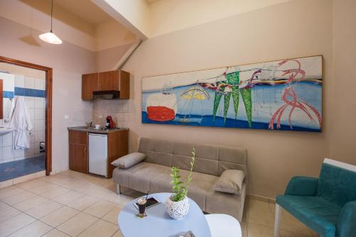 a living room filled with furniture and a painting on the wall at Studios Kiara in Chania Town