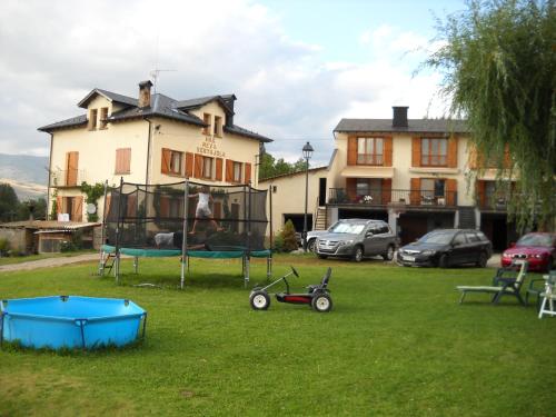 a yard with a playground in front of a house at Mas Meya in Puigcerdà