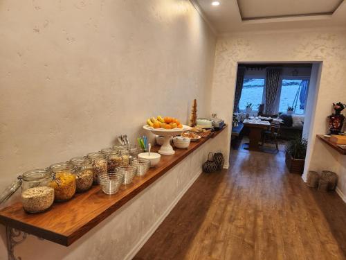 a long counter with bowls of food on it at Bed and Breakfast Am Knittenberg in Winterberg