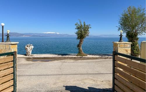 a gate with a view of the water at Amazing Home In Diakopto Achaias P in Diakopto