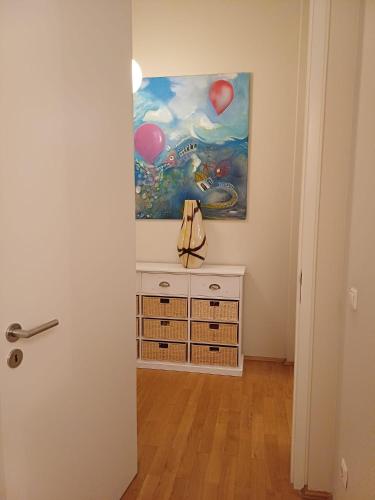 a painting on the wall above a dresser in a room at Tillyhome in Nürnberg