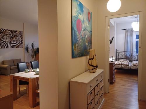 a living room with a table and a painting on the wall at Tillyhome in Nürnberg