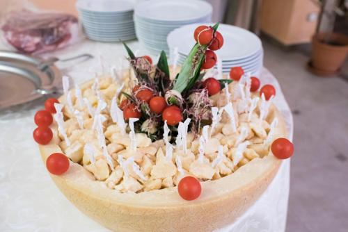 a dessert with cheese and fruit on a table at Grand Hotel Stella Maris Italia in Palmi