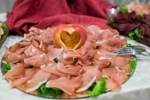 a plate of food with an apple and broccoli at Grand Hotel Stella Maris Italia in Palmi