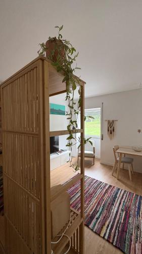 a room with a wooden cabinet with a plant on it at CASA da Corredoura by NaturAlegre in Portalegre