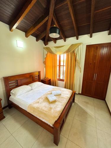 a bedroom with a large bed with a wooden headboard at VILLA ORION piscina y discoteca PRIVADA K18 in Cali