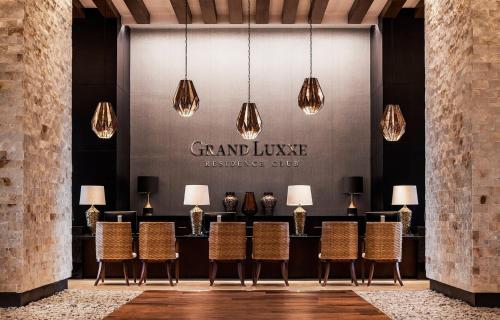 a group of chairs in front of a table with lights at 2BD Grand Luxxe Villa Nuevo in Nuevo Vallarta 