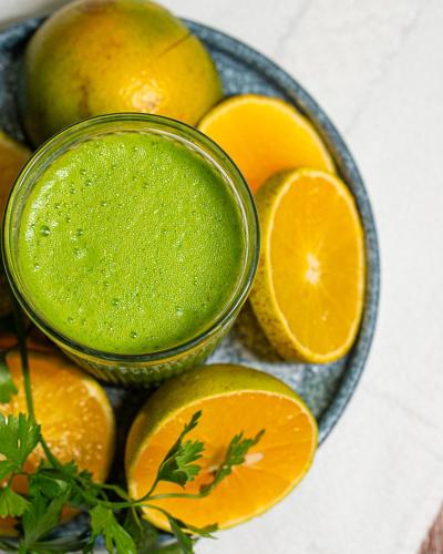 a bowl of green juice next to some oranges at Hotel Casa Vertiz in Oaxaca City