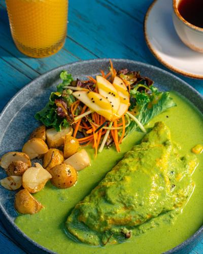 a plate of food with a green dip and a salad at Hotel Casa Vertiz in Oaxaca City