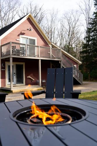 a fire pit in front of a house at The Aurora Inn & Cottages in Bartlett