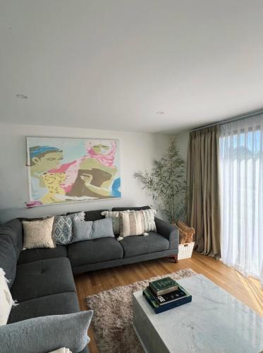 a living room with a couch and a table at California 'Luxe Boho' with Pool in Echuca