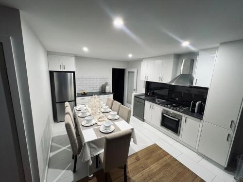 a kitchen with a table and chairs in a kitchen at California 'Luxe Boho' with Pool in Echuca