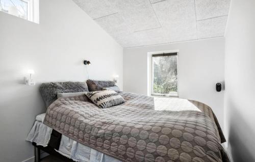 a bedroom with a bed and a window at 2 Bedroom Lovely Home In Assens in Assens