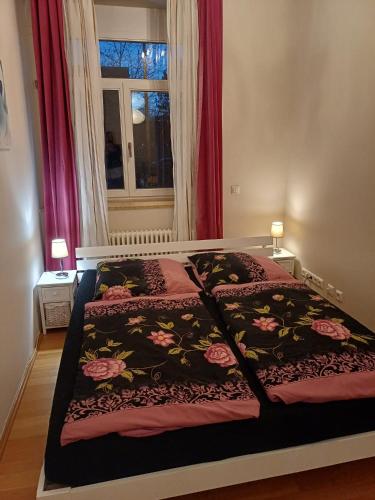 a bedroom with a bed with a blanket on it at Tillyhome in Nürnberg
