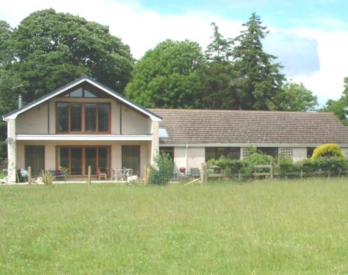 a house with a grass field in front of it at Ballacowell in Sulby