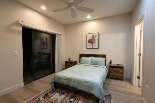 a bedroom with a bed and a ceiling fan at Central To Phoenix and Scottsdale Spacious 3BR Escape in Phoenix! in Phoenix
