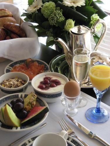 a table with plates of food and glasses of wine at Grand Hotel Belle Vue in De Haan