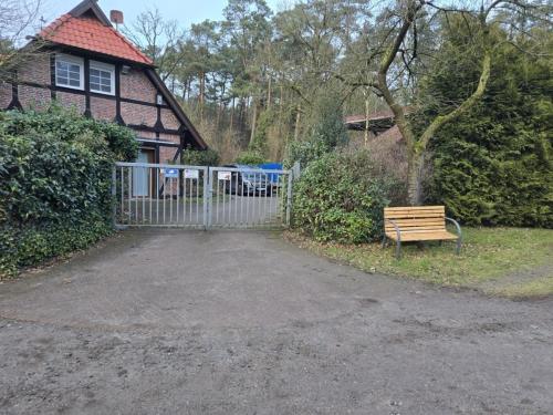 a wooden bench sitting in front of a house at Ahauser Ferien- und Business-Appartement 29qm in Ahausen