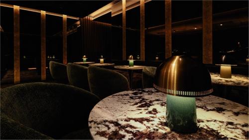 a table with a lamp on top of it in a restaurant at InterContinental Singapore Robertson Quay by IHG in Singapore