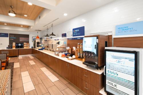 a grocery store aisle with a cash register and a counter at Holiday Inn Express Hotel & Suites Coeur D'Alene I-90 Exit 11 by IHG in Coeur d'Alene