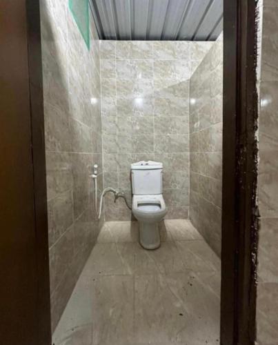 a bathroom with a toilet and a tiled shower at Wadi Rum Heaven Camp in Wadi Rum