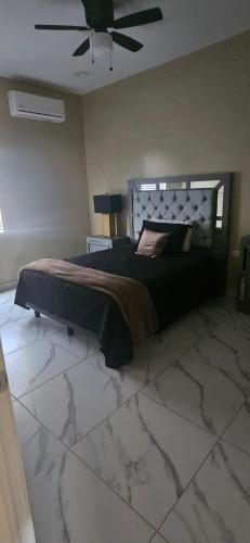 a bedroom with a bed and a ceiling fan at Sofia apartment in Puerto Peñasco