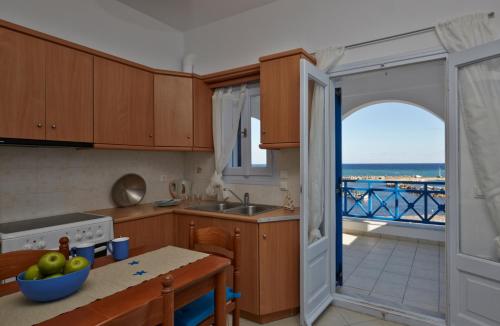 a kitchen with a view of the ocean at Rodothea and Adams on the Beach, Santorini in Monolithos