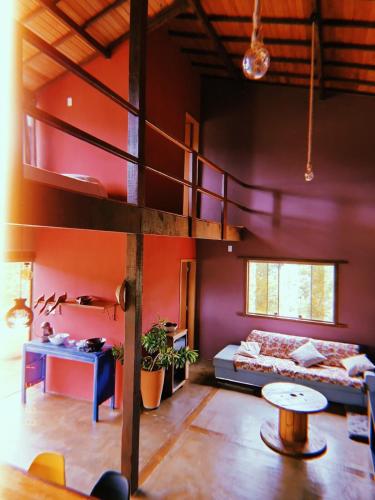 a bedroom with a bunk bed and a loft at Morada da Terra Lapinha da Serra in Santana do Riacho