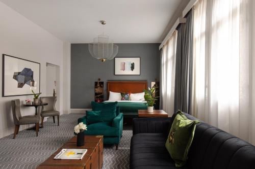 a living room with a couch and a bed at Kimpton Clocktower by IHG in Manchester