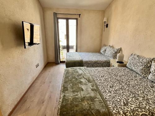a bedroom with two beds and a window at Val'quirico Auguri Zócalo II, Depto 5 Camas in Santeagueda