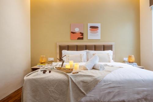a bedroom with a bed with candles on it at La Ferringhi Villa - Balinese Collection, by ALV in Batu Ferringhi