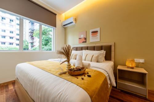 a bedroom with a large bed with a basket on it at La Ferringhi Villa - Balinese Collection, by ALV in Batu Ferringhi