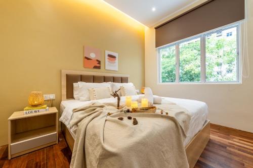 a bedroom with a large bed and a window at La Ferringhi Villa - Balinese Collection, by ALV in Batu Ferringhi