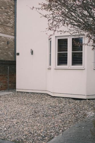 a white house with a window on the side of it at Luxury Private Room in Central Oxford - Great Location in Oxford