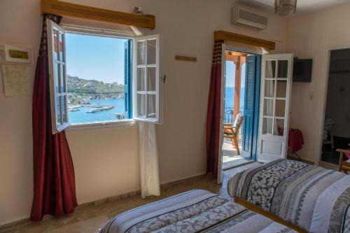 a bedroom with two beds and a view of the ocean at Melina's Sunset in Myrties