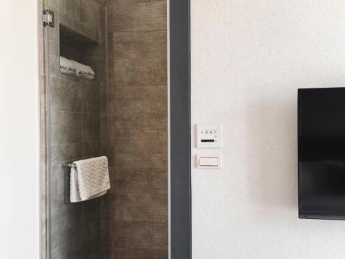 a bathroom with a shower with a towel at 漫漫日出海景民宿 證號2094 in Hualien City