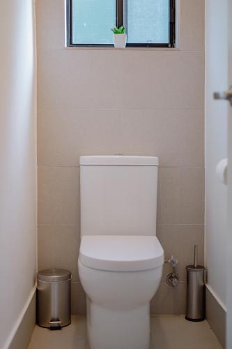 a white toilet in a bathroom with a window at Candlebark at Boardwalk Villas in Metung