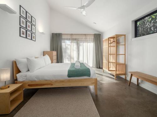 a bedroom with a large bed and a window at Birdsong Blackheath in Blackheath