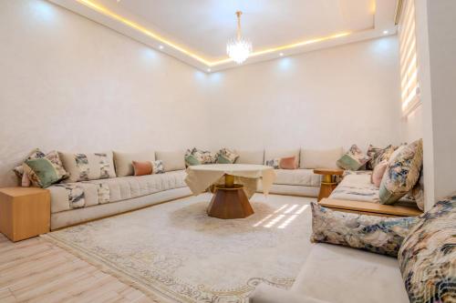 a living room with a couch and a table at FAMiLY HOME in Agadir