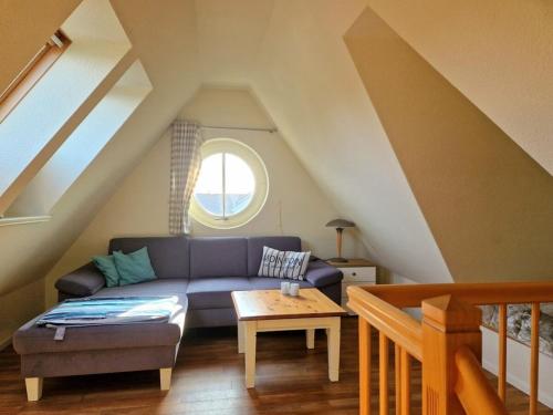 a living room with a couch and a table at Holiday apartment in Wyk with swimming pool in Wyk auf Föhr