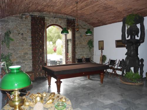 a pool table in a room with a stone wall at U Palazzu Corte in Corte