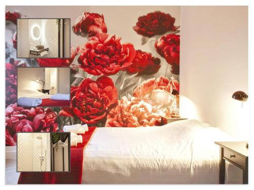 a bedroom with red flowers on the wall at Waterfront Holiday Home with Terrace Views in Stavoren