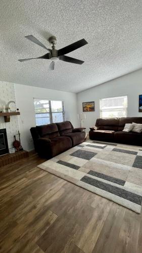 a living room with a couch and a ceiling fan at House with lake view in Port Richey