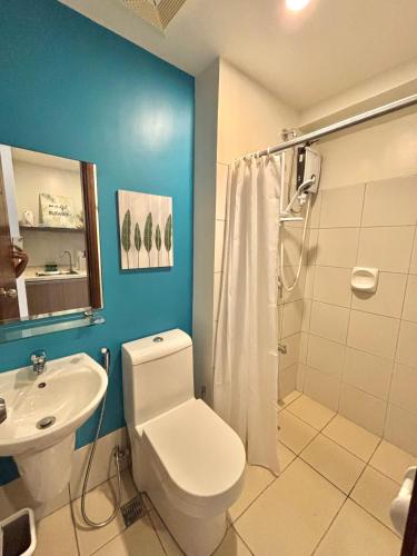 a bathroom with a toilet and a sink and a shower at Cebu Property Express in Cebu City