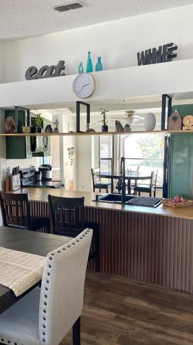 a kitchen with a counter with a table and chairs at House with lake view in Port Richey
