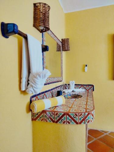 a bathroom with a towel rack and a mirror at Estrella - Casa MoJo's airy 2BR, kitchen, pool in Sayulita